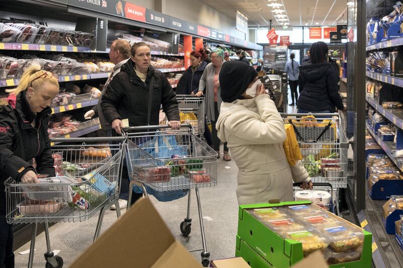 LONDON, ENGLAND - MARCH 23: Shoppers in an Aldi supermarket ahead of opening on March 23, 2020 in London, England. Coronavirus (COVID-19) pandemic has spread to at least 182 countries, claiming over 10,000 lives and infecting hundreds of thousands more. (Photo by Dan Kitwood/Getty Images)