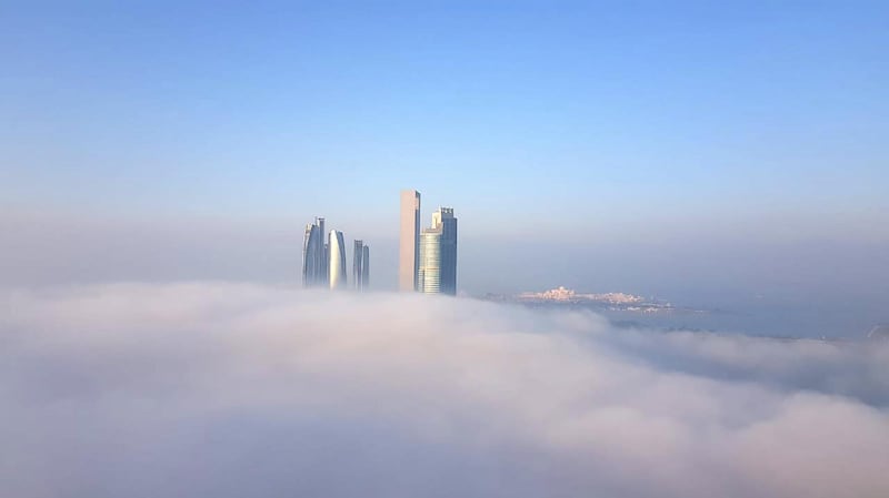 Dense fog blankets the Abu Dhabi skyline with Etihad Towers visible. Erica ElKhershi / The National