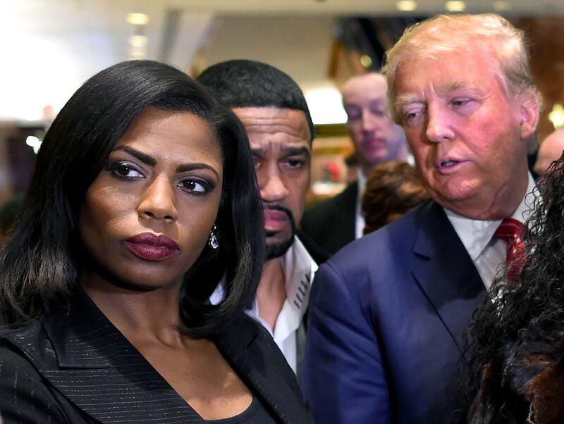 (FILES) In this file photo taken on December 01, 2015, Omarosa Manigault Newman (L) appears alongside Republican presidential hopeful Donald Trump (R) during a press conference that followed Trump's meeting with African-American religious leaders in New York. - US resident Donald Trump on August 14, 2018, lashed out at his former White House aide Omarosa Manigault Newman in especially angry terms, slamming her as a "dog" and "crazed" as their mud-slinging match escalated. (Photo by Timothy A. CLARY / AFP)