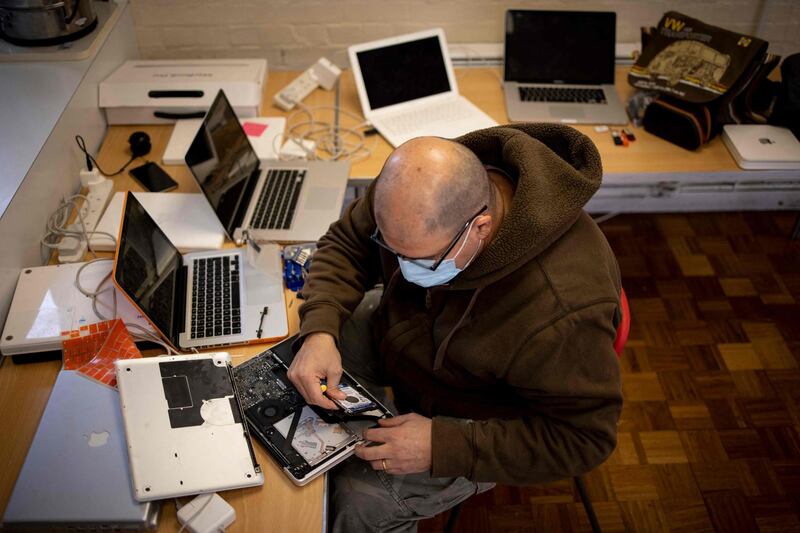 A member of the team at Catbytes repairs a donated computer. AFP