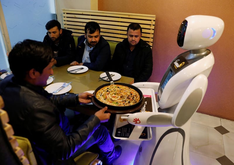 Timea brings food to a table at the Times Fast Food restaurant in Kabul, Afghanistan. Reuters