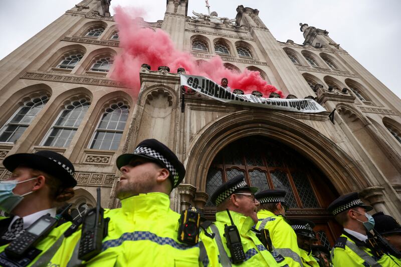 Extinction Rebellion climate activists drape a banner from the Guildhall in London. The campaign group is gearing up for two weeks of demonstrations. Reuters