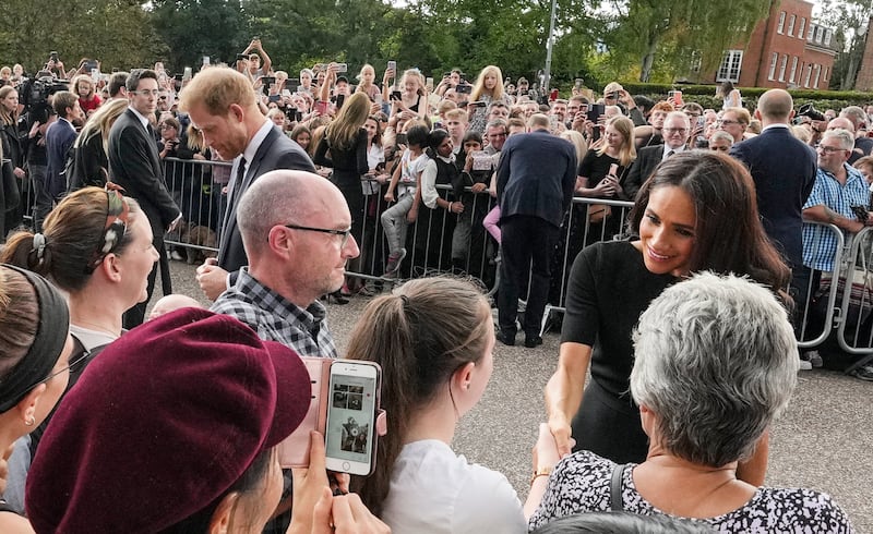 The royals speak and shake hands with different sides of the cheering crowds. AP