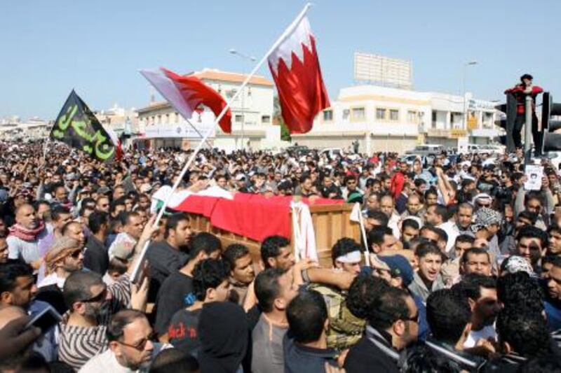 Bahraini Shiite protesters carry the coffin of a comrade who died a day earlier from his wounds following clashes with police, during his funeral in the town of Jidhafs, near the capital Manama, on February 15, 2011. AFP PHOTO/ADAM JAN