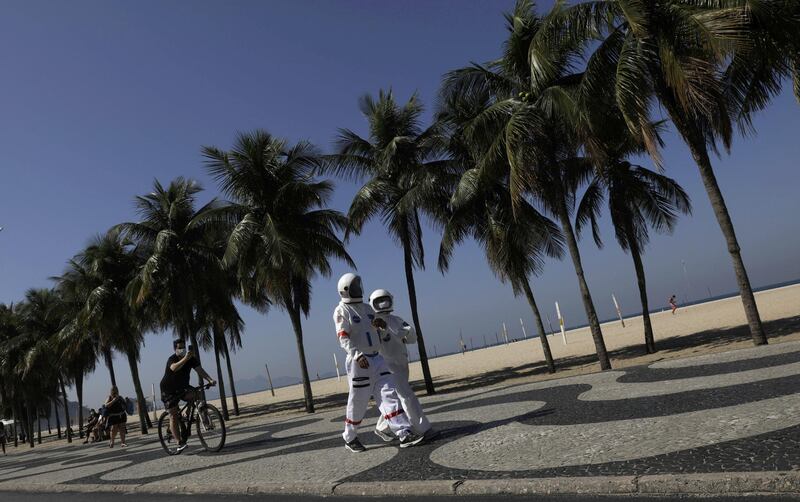Tercio Galdino, 66, and his wife Aliceia, 65, wear their protective 'space suits' as they walk on the sidewalk of Copacabana Beach amid the outbreak of the coronavirus disease (COVID-19) in Rio de Janeiro, Brazil. Reuters