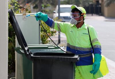 Dubai, United Arab Emirates - Reporter: N/A: People disinfect bins in Jumeirah in response to the corona virus. Wednesday, March 25th, 2020. Dubai. Chris Whiteoak / The National