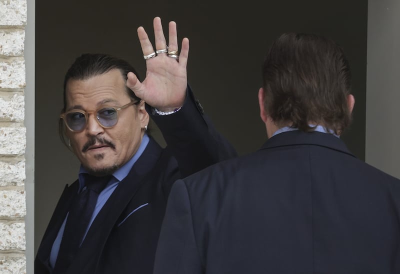 Depp waves to screaming fans on a break. Getty Images / AFP
