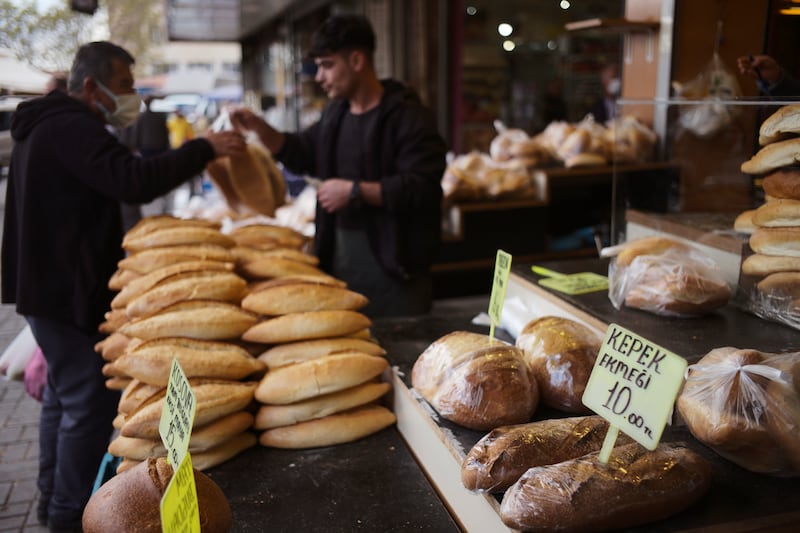 A man buys bread in Turkey's capital Ankara. Russia's military assault in Ukraine has triggered a commodities super cycle which has acerbated food inflation across the globe. AP Photo