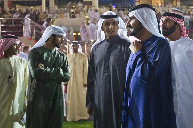 United Arab Emirates -Dubai- March 28, 2009:

NEWS: Sheikh Mohammed Bin Rashid Al Maktoum, center right in blue, and his family stand in the winner's circle after Gladiatorus (cq-al), the horse of his son Mansoor Bin Mohammed Al Maktoum, won the Dubai Duty Free race at the 2009 Dubai World Cup in the Nad Al Sheba Racecourse in Dubai on Saturday, March 28, 2009. Amy Leang/The National  
 *** Local Caption ***  amy_032809_dubaiworldcup_22.jpg