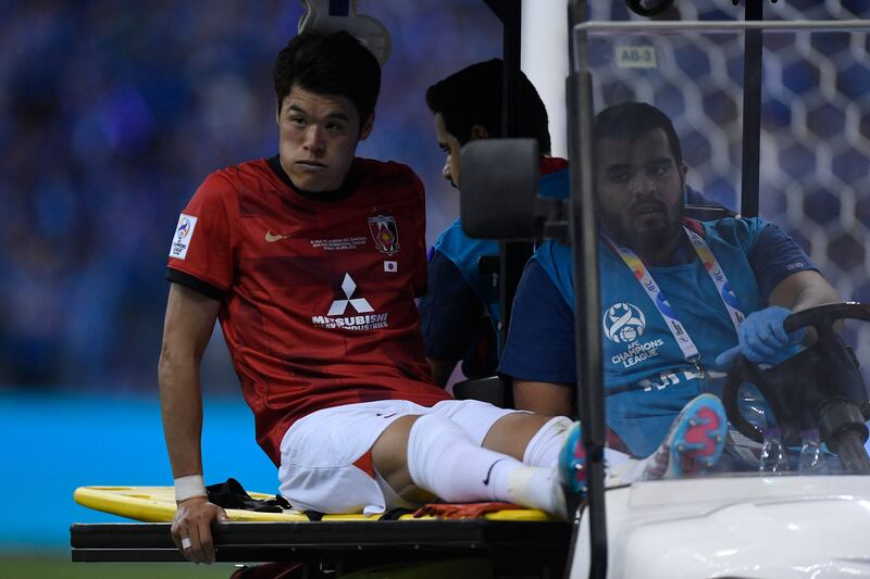 Urawa defender Hiroki Sakai is taken off the pitch following an injury. AFP