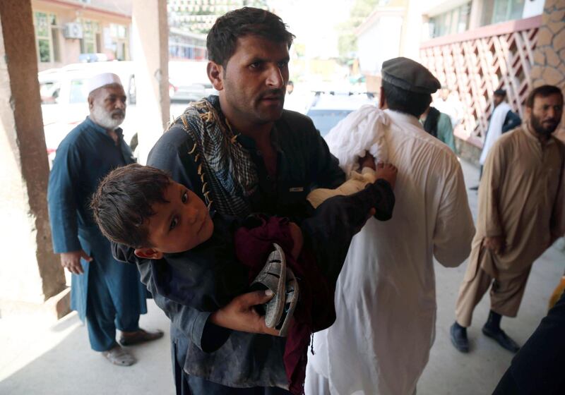 A young boy injured in a twin suicide bomb blasts at a girl's schools, is rushed to hospital in Jalalabad, Afghanistan.  EPA