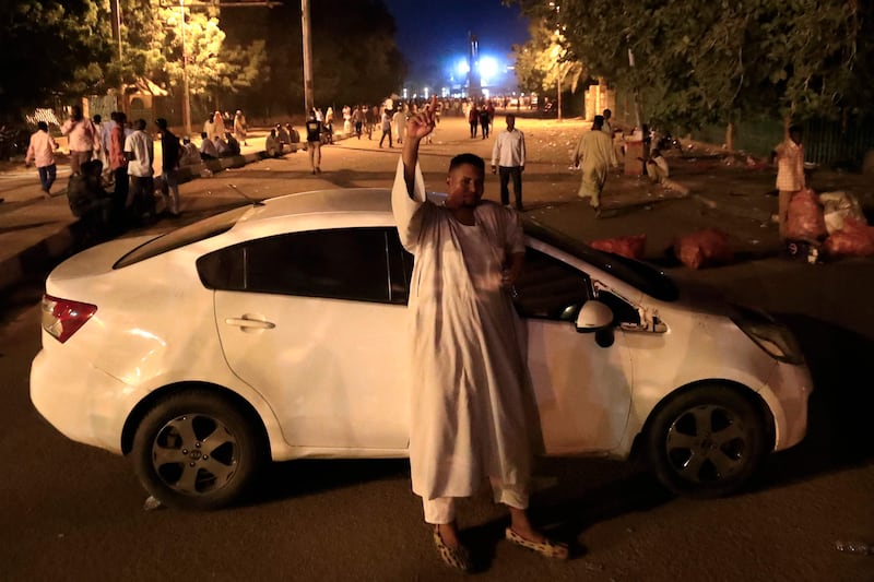 A protester blocks a street with his car during a demonstration to demand the dissolution of Sudan's transitional government. AFP