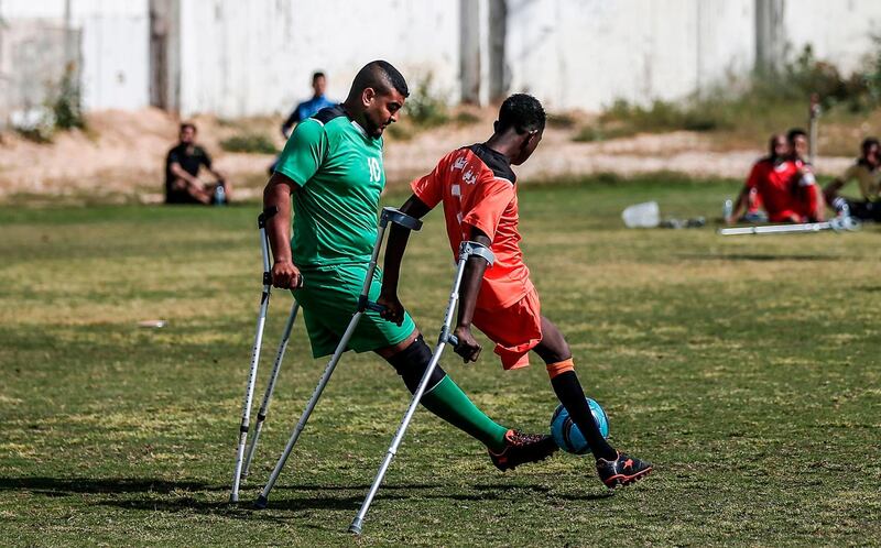 Palestinian amputees play in a football match overseen by Irish coach Simon Baker, general secretary of the European Amputee Football Federation, in Gaza City.  AFP