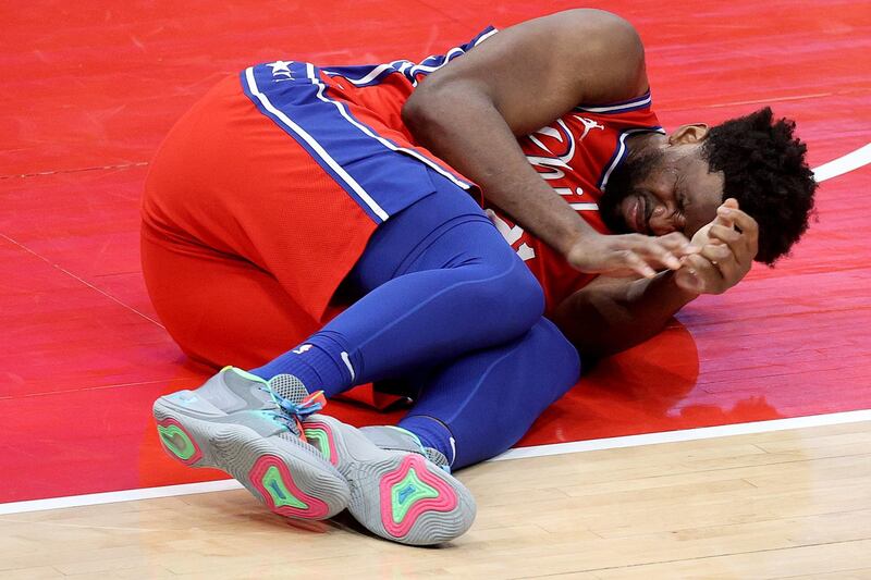 WASHINGTON, DC - MARCH 12: Joel Embiid #21 of the Philadelphia 76ers reacts after getting injured in the second half against the Washington Wizards at Capital One Arena on March 12, 2021 in Washington, DC. DC. NOTE TO USER: User expressly acknowledges and agrees that, by downloading and or using this photograph, User is consenting to the terms and conditions of the Getty Images License Agreement.   Rob Carr/Getty Images/AFP
== FOR NEWSPAPERS, INTERNET, TELCOS & TELEVISION USE ONLY ==

