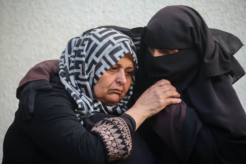 Mourners wait to collect the bodies of relatives killed in an airstrike on January 12, in Rafah. Getty Images