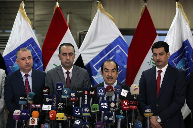 TOPSHOT - Riyadh al-Badran (C), the head of Iraq's Independent Higher Election Commission (IHEC), speaks during a press conference, in the presence of the nine members of the IHEC, on May 31, 2018, in Baghdad. Since the May 12 victory of anti-establishment electoral lists, long-time political figures pushed out by Iraqi voters hoping for change have called for a recount -- with some even calling for the poll results to be cancelled. / AFP / AHMAD AL-RUBAYE
