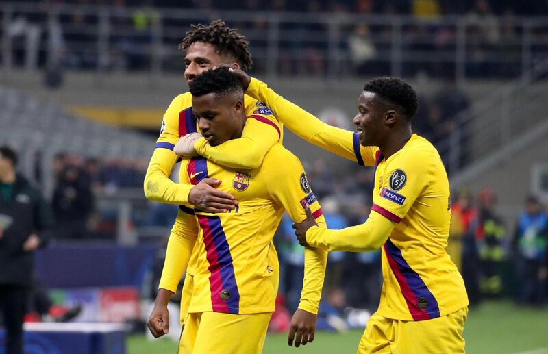 epa08061276 FC Barcelona's Ansu Fati (C) celebrates with teammates Jean-Clair Todibo (L) and Moussa Wague after scoring during the UEFA Champions League group F soccer match between FC Inter and FC Barcelona at the Giuseppe Meazza stadium in Milan, Italy 10 December 2019.  EPA/ROBERTO BREGANI