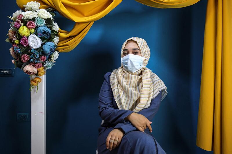 A woman poses for a commemorative picture at Palestinian photoghrapher Faten Issa's studio in Rafah in the southern Gaza Strip. AFP