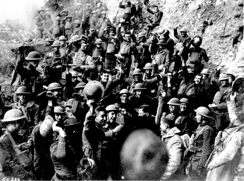 American troops, near St. Mihiel, France, cheer after hearing the news that the Armistice has been signed.