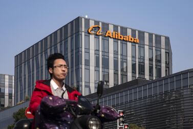 A motorist drives past an Alibaba office building in Shanghai. Alibaba has shed more than $230bn in value from its recent peak as authorities have increased scrutiny over China's largest technology firms. Bloomberg