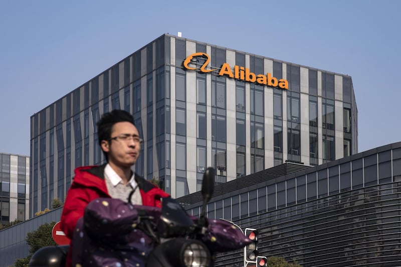 A motorist travels past an Alibaba Group Holding Ltd. office building in Shanghai, China, on Thursday, Dec. 24, 2020. China kicked off an investigation into alleged monopolistic practices at Alibaba and summoned affiliate Ant Group Co. to a high-level meeting over financial regulations, escalating scrutiny over the twin pillars of billionaire Jack Ma’s internet empire. Photographer: Qilai Shen/Bloomberg