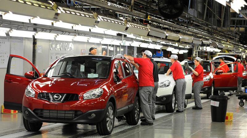 FILE PHOTO: A worker is seen completing final checks on the production line at Nissan car plant in Sunderland, northern England, June 24, 2010. REUTERS/Nigel Roddis/File Photo