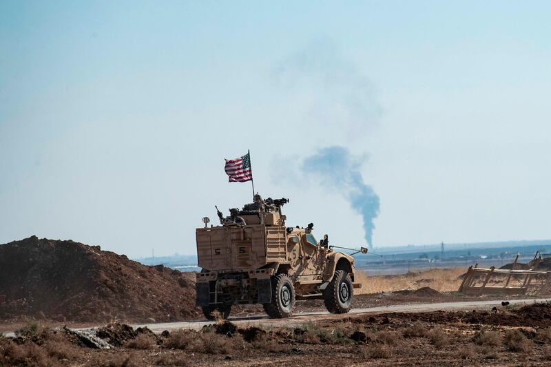 A US armoured vehicle patrols the village of Ein Diwar in Syria's northeastern Hasakeh province.  AFP