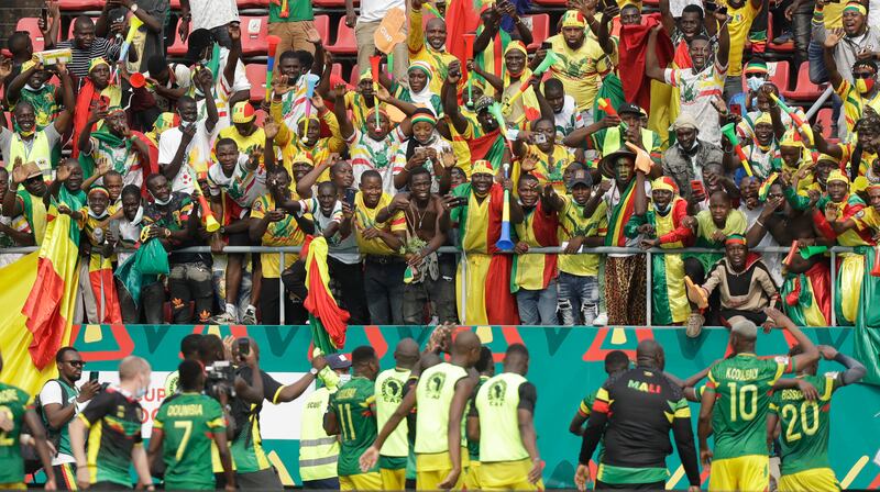 Mali supporters and players celebrate at the end of the match. AP