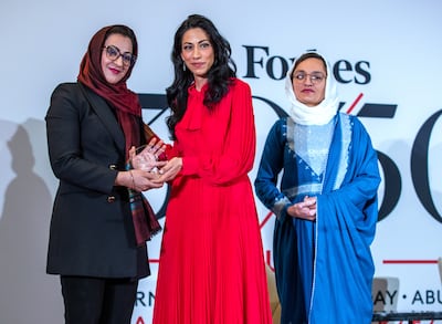 Huma Abedin, advisor to Hillary Clinton, hands the Forbes 30/50 Changemaker Award to Naheed Farid, left, and Zarifa Ghafari.
Victor Besa / The National