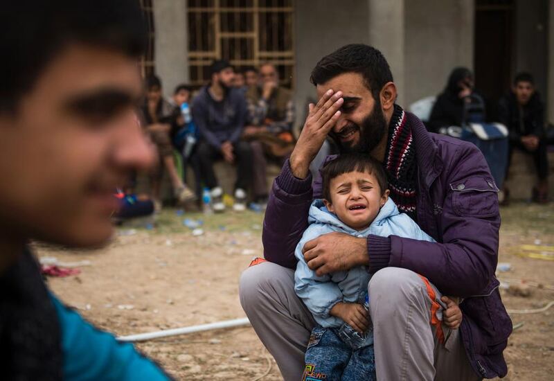 Iraqis fleeing the fighting rest as they reach an area held by Iraqi Special Forces 2nd division for transport out of the combat zone in the Samah neighbourhood of Mosul. Hundreds of people used the opportunity to try and get out of harms way during a period of relative calm on the frontline neighbourhoods of eastern Mosul. AFP