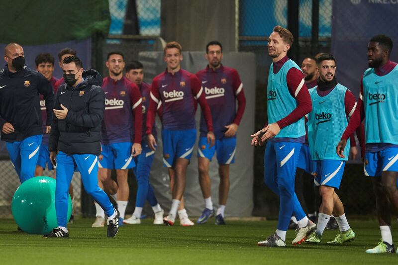 Barcelona's head coach Xavi walks by Dutch player Luuk De Jong. EPA