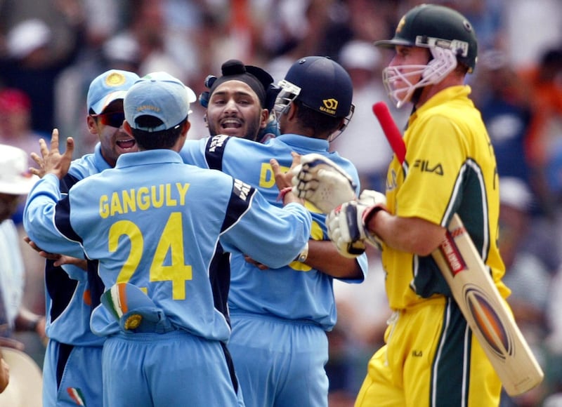 Indian spinner Harbhajan Singh (C) celebrates with teammates after dismissing Australian batsman Matthew Hayden (R) in the final of the ICC Cricket World Cup being played at the Wanderers Stadium in Johannesburg 23 March 2003.  Batting first, Australia is 144-2 after 23 overs.  AFP PHOTO/William WEST (Photo by WILLIAM WEST / AFP)