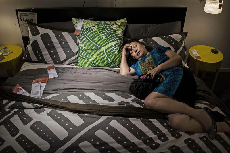 A Chinese shopper sleeps on a bed in the showroom of the IKEA store on July 6, 2014 in Beijing, China. Of the world’s ten biggest Ikea stores, 8 of them are in China to cater to the country’s growing middle class. The stores are designed with extra room displays given the tendency for customers to make a visit an all-day affair. Store management does not discourage shoppers from sleeping on Ikea furniture, even marking them with signs inviting customers to try them out. Kevin Frayer / Getty Images