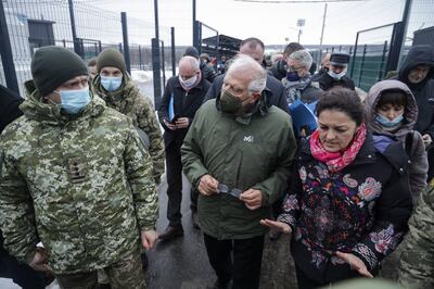 Mr Borrell speaks to Ukrainian servicemen during his visit to the Stanitsa Luganskaya border crossing. EPA