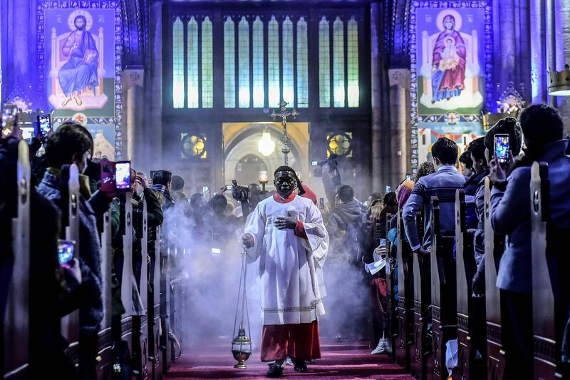 A priest attends Christmas Mass at Saint Antuan Church in the Beyoglu district of Istanbul on December 24, 2017. Yasin Akgul / AFP