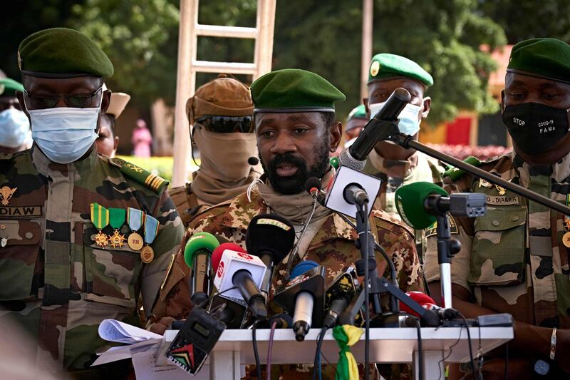 (FILES) In this file photo taken on September 22, 2020 Colonel Assimi Goita (C), President of CNSP (National Committee for the Salvation of People) addresses to the press during the ceremony of the 60th anniversary of Mali's independence in Bamako, one day after announcing that the transitional presidency would be assigned to a retired colonel, Bah Ndaw, 70 years, ephemeral Minister of Defence in 2014. Malian officers upset with a government reshuffle have detained the president and prime minister at an army camp outside the capital, triggering broad international condemnation and demands for their immediate release. President Bah Ndaw and Prime Minister Moctar Ouane lead an interim government that was installed under the threat of regional sanctions following a putsch in August, and the detentions on May 24, 2021 raised fears of a second coup. Briefly reached by phone before the line cut, Prime Minister Ouane told AFP that soldiers affiliated with interim Vice President Colonel Assimi Goita "came to get him". / AFP / MICHELE CATTANI

