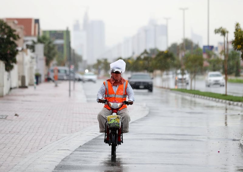 Dubai, United Arab Emirates - Reporter: N/A: Weather. A motor cyclist rides covers his face and has a bag on his head to stay dry as the rain comes down in Dubai. Saturday, March 21st, 2020. Jumeirah, Dubai. Chris Whiteoak / The National