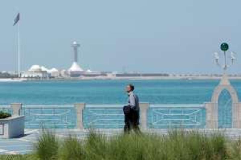 ABU DHABI, UNITED ARAB EMIRATES - April 6, 2009: A man walks on the corniche of Abu Dhabi. 
( Ryan Carter / The National )

*** stock *** Local Caption ***  RC007-Stock.JPG