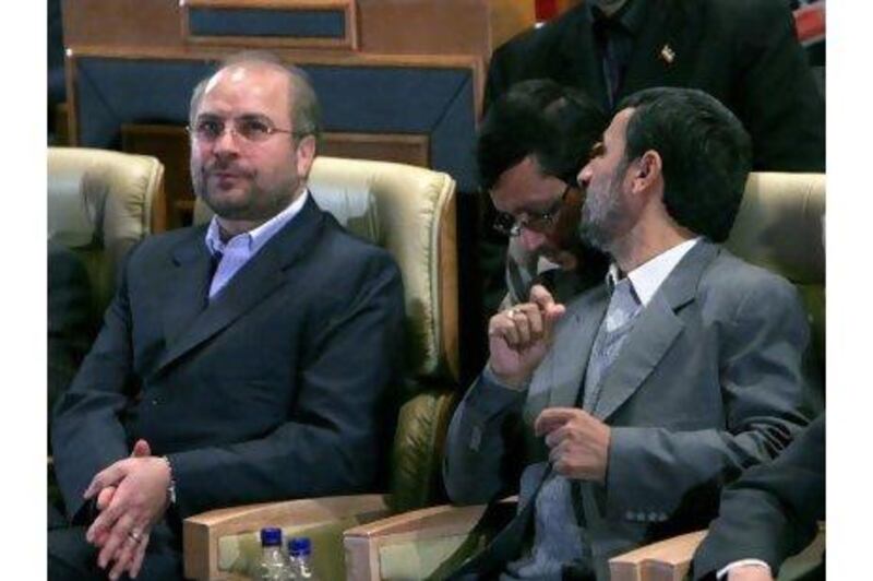 Iranian president Mahmoud Ahmadinejad, right, talks with a colleague as the mayor of Tehran, Mohammad Qalibaf, left, looks on.