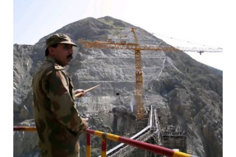 The Pakistani army's construction agency is helping to rebuild South Waziristan by doing survey work on the Gomal Zam Dam. Above, Colonel Muhammad Zaheer inspects the site of the US-funded dam. Anwar Shakir / Bloomberg News