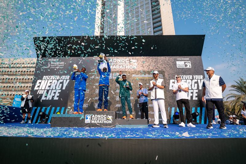Dr Sultan Al Jaber,  Minister of Industry and Advanced Technology and Adnoc managing director, with Kenyan Timothy Kiplagat and winners of the Adnoc Abu Dhabi Marathon on Saturday. Wam