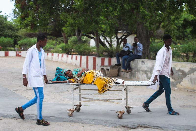 epa07737935 Medics carry a woman who was injured in a blast on a stretcher at Medina hospital in Mogadishu, Somalia, 24 July 2019. According to reports, a suicide bomber walked into the office of Mogadishu's mayor, Abdirahman Omar Osman, before blowing himself up. Several government officials, including the mayor, have been injured in the attack and at least five people were killed. No one immediately claimed the responsibility for the attack but the country's Islamist militant group al-Shabab often carries out such attacks in the capital against its western-backed government.  EPA/SAID YUSUF WARSAME