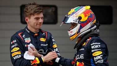 Red Bull's Max Verstappen, left, celebrates after qualifying in pole position along with second-placed Sergio Perez. Reuters