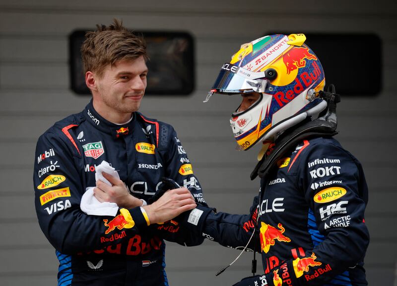 Red Bull's Max Verstappen, left, celebrates after qualifying in pole position along with second-placed Sergio Perez. Reuters
