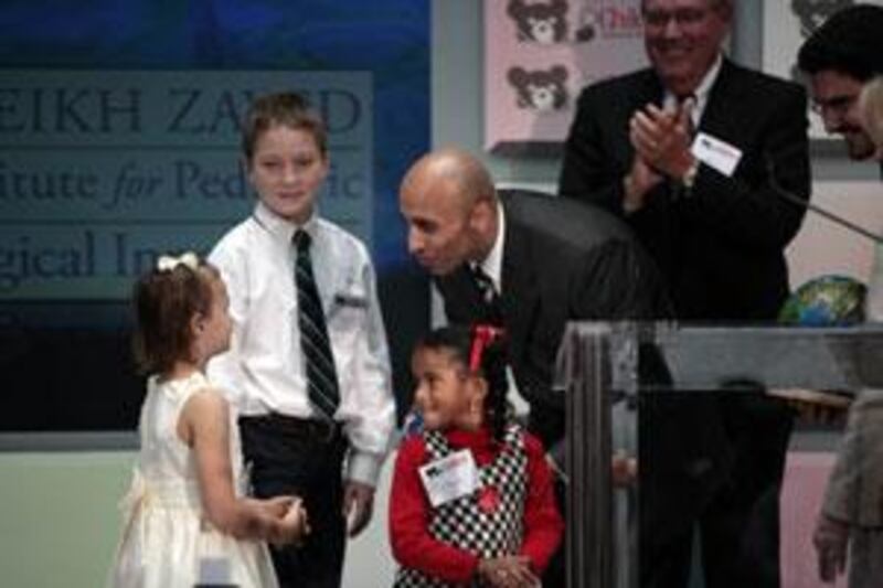 Ambassador Yousef Al Otaiba accepts gifts from children at a press conference at Children's National Medical Center, September 16, 2009, in Washington.