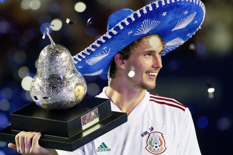 Germany's Alexander Zverev celebrates with the trophy after winning the Mexican Open. Reuters