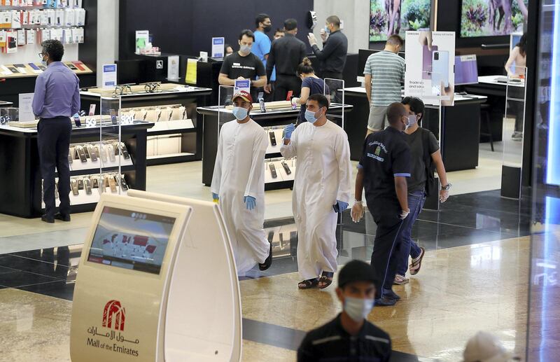 DUBAI, UNITED ARAB EMIRATES , April 29 – 2020 :- Shoppers wearing protective face mask to prevent the spread of the coronavirus at Mall of the Emirates in Dubai. Authorities ease the restriction for the residents in Dubai. At present mall opening timing is 12:00 pm to 10:00 pm. Carrefour timing is 9:00 am to 10:00 pm. (Pawan Singh / The National) For News/Standalone/Online. Story by Patrick