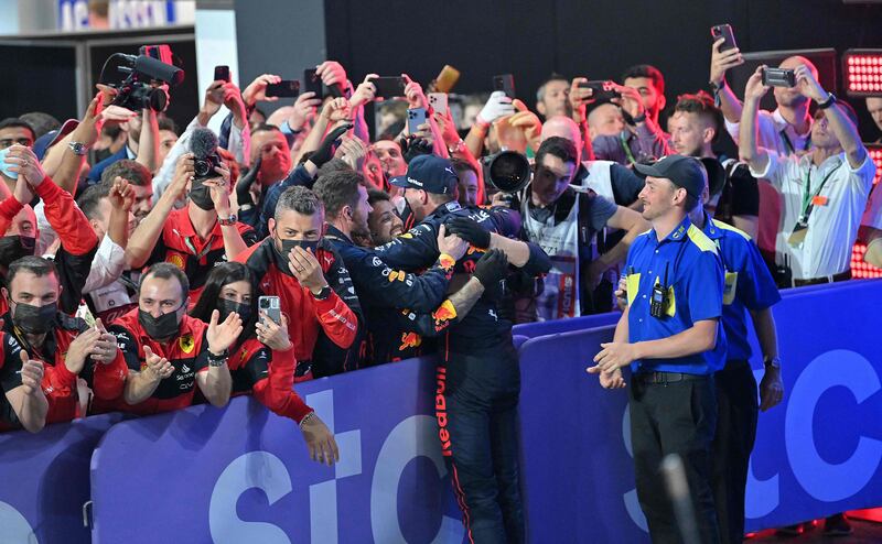 Verstappen celebrates with his team. AFP