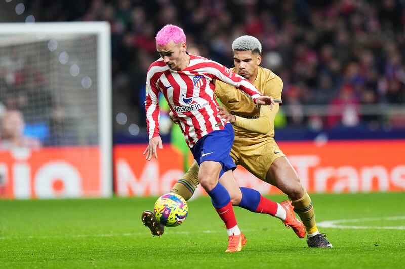 Antoine Griezmann of Atletico Madrid is challenged by Ronald Araujo of Barcelona. Getty Images