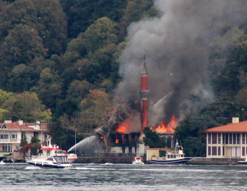 A fire engulfs Vanikoy Mosque, a historic wooden mosque, in Istanbul, Sunday, Nov. 15, 2020. The Vanikoy Mosque, built in the 17th century during the reign of Ottoman Sultan IV Mehmed, is located on the Asian side of Istanbul along the Bosporus Strait. Turkish firefighters were trying to put out the blaze from both land and sea. (DHA via AP)